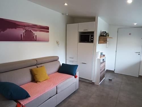 - un salon avec un canapé et des oreillers colorés dans l'établissement Studio en Provence avec accès à la piscine de la propriété, à Velleron