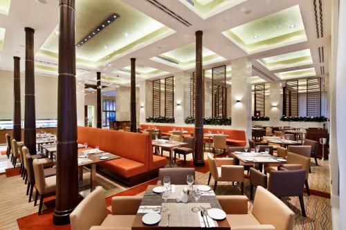 an image of a restaurant with tables and chairs at Hilton Garden Inn Mardin in Mardin