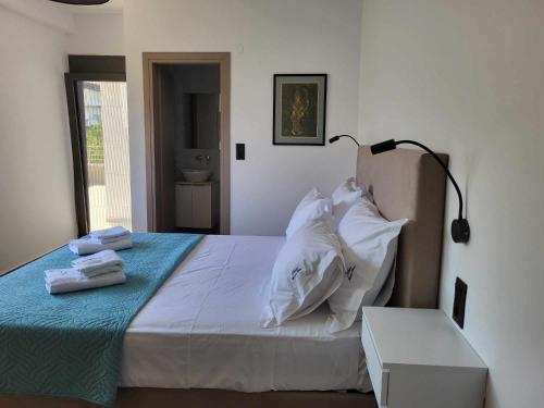 a bedroom with a bed with towels on it at White Boutique Homes - Euphoria in Metókhion Apisianá