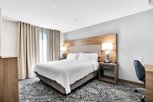a hotel room with a bed and a window at Candlewood Suites Atlanta West I-20 by IHG in Lithia Springs