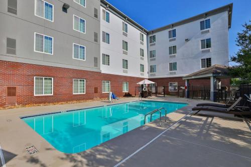 einem Pool vor einem Gebäude in der Unterkunft Candlewood Suites Atlanta West I-20, an IHG Hotel in Lithia Springs