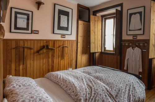 a bedroom with wooden walls and a bed with a blanket at Sintra Small Hostel in Sintra