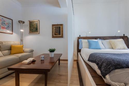 a bedroom with a bed and a couch and a table at Juvarra Point by Wonderful Italy in Turin