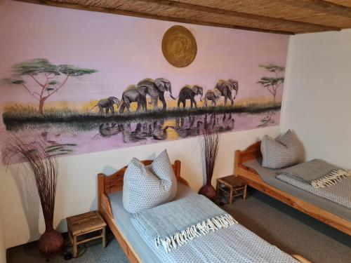 a room with two beds and a painting on the wall at Zur Sonnenblume 