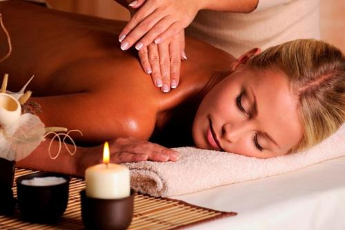 a woman getting a massage in a spa tub at Wellness hotel Sauna in Malá Morávka
