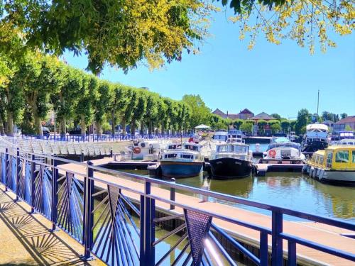 a bunch of boats parked in a marina at Le T3 Confort - Au Cœur de Montceau in Montceau-les-Mines