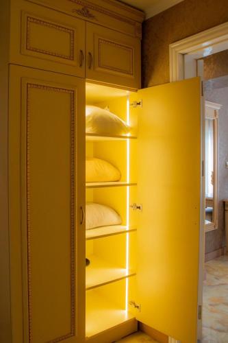 a yellow closet with yellow pillows in it at Luxury Apartment 'Rich' in Velingrad