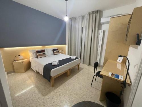 a hotel room with a bed and a desk at Ciccio Rooms and breakfast - Self check-in in Palermo