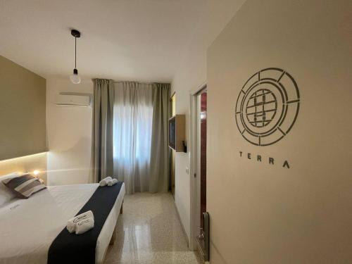 a hotel room with a bed and a sign on the wall at Ciccio Rooms and breakfast - Self check-in in Palermo