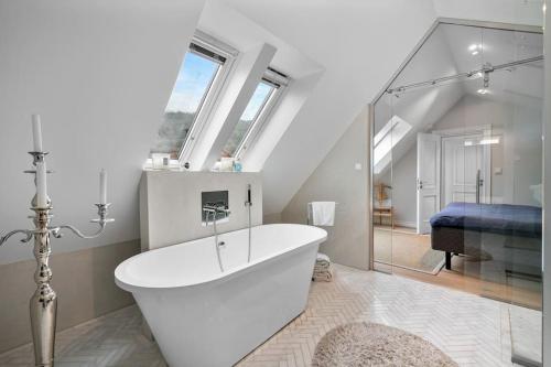 a white bath tub in a bathroom with a window at Beautiful townhouse super Central in Bergen - 4 bedrooms 8 guests in Bergen
