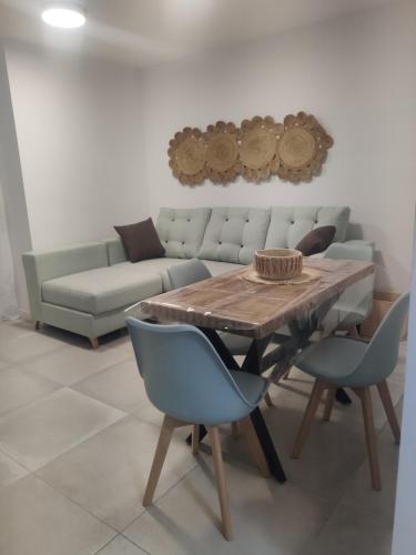 a living room with a couch and a table and chairs at SUDAMERICA38 in Roquetas de Mar
