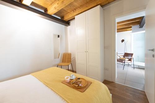 a bedroom with a bed with a yellow blanket at Ortigia Suite - Theater in Syracuse