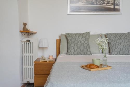 a bed with a tray with a croissant on it at Simons Apartment with Amazing View by Rent All Como in Blevio