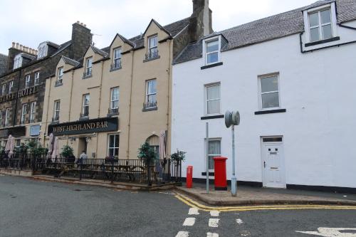 a row of buildings on the corner of a street at MacDonald House in Portree