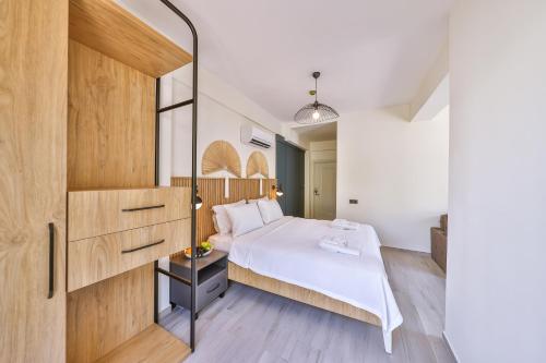 a bedroom with a white bed and a wooden wall at Kas Athena Hotel in Kas