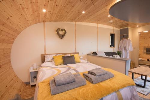 a bedroom with a bed with two pillows on it at Fern - Beacon View Pods in Knighton