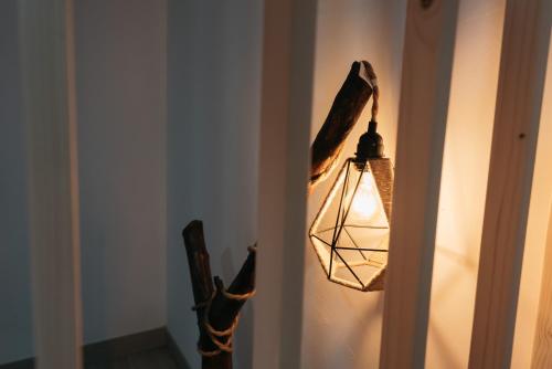 a light hanging from a wall with a lamp at Casa Luna Rural Con Piscina y Jardín in Ourense