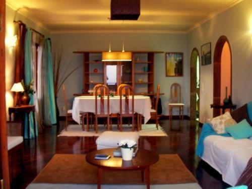 a living room with a table and a couch at Villa São Paulo in Funchal