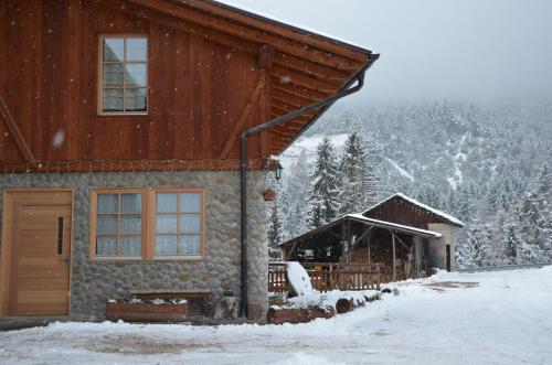 a house with snow on the side of it at Agritur Maso Forcola in Brez