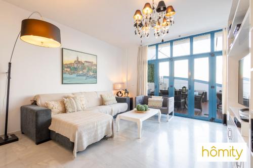 a living room with a couch and a table at Exclusive Castell de Ferro - Castell Playa in Castell de Ferro