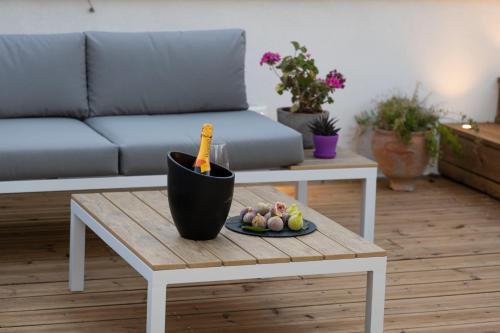 a living room with a table with a bottle of champagne at Porta Vetere - Boutique Rooms in Trani