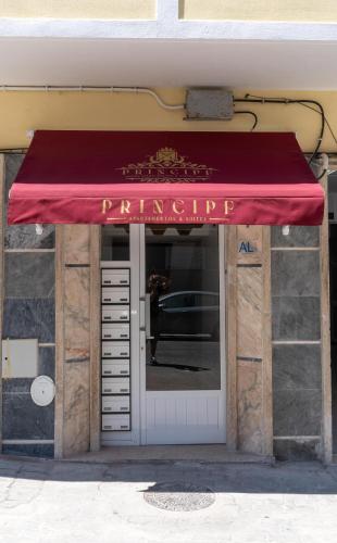 a red awning over the door of a building at Príncipe Apartamentos e Suites in Lisbon