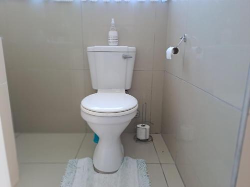 a bathroom with a toilet with a bottle on top of it at 4 On Hoffman Seaview in Agulhas
