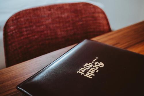 a laptop sitting on top of a wooden table at Hotel Brücklwirt in Niklasdorf