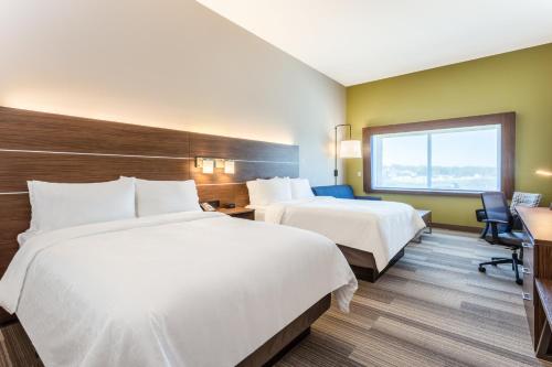 a hotel room with two beds and a desk at Holiday Inn Express & Suites - Springfield North by IHG in Springfield