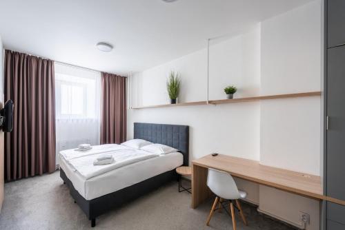 a hotel room with a bed and a desk at HONEST Smichov in Prague