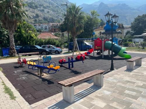 a park with a playground with a slide and a bench at Sunshine of Montenegro - Luxury in Kotor