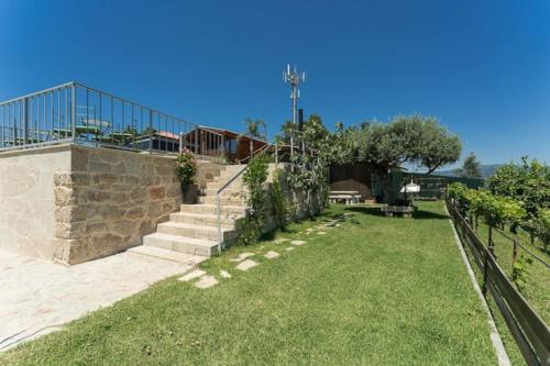 a set of stairs in a yard with grass at Fernandes Guest House Sunshine Studio in Ponte de Lima