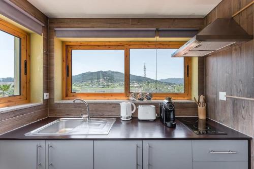 a kitchen with a sink and a window at Fernandes Guest House Sunshine Studio in Ponte de Lima
