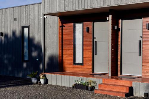 a house with two doors on the side of it at Wamoon Retreat - Luxe House in Yanakie