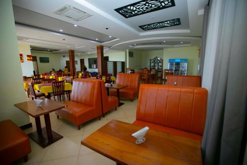 a restaurant with orange furniture and tables and chairs at Snow View Annex in Himo