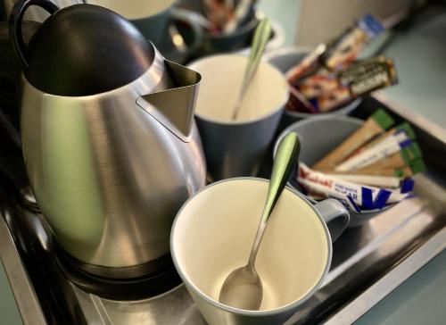 a counter with two cups and a tea kettle at Bannister Hotel in Johannesburg