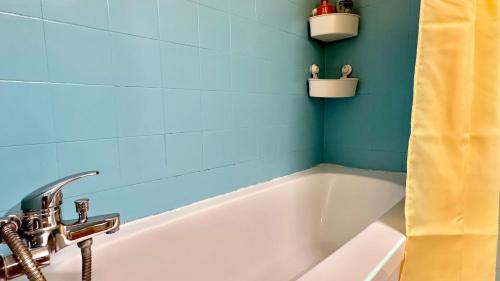 a bathroom with a bath tub and a sink at GW317 Gugel Waves Amazing Seaview Pool Apartments in Nahariyya