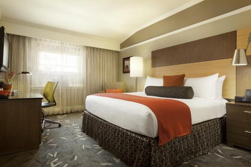 a hotel room with a large bed and a desk at Hotel Abri Union Square in San Francisco