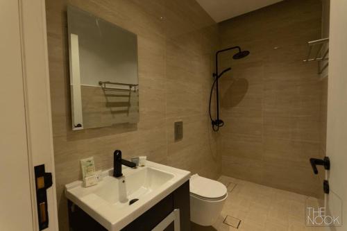 y baño con lavabo, aseo y espejo. en شقة فخمة 3 غرف نوم في حي الملقا قريبه من البوليفارد The Nook, luxury 3BD Flat in malqa district near BLVD, en Riad