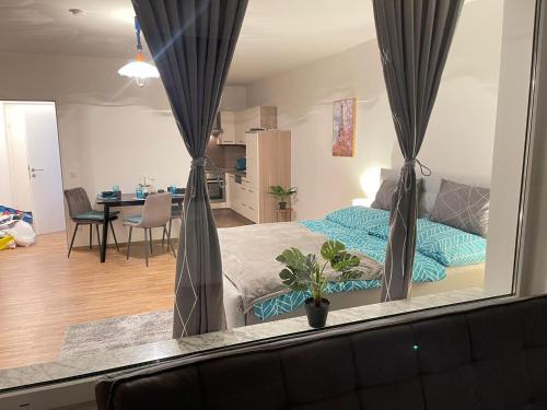 a bedroom with a bed and a living room at Ferienwohnung Marion Klagenfurt Wörthersee Viktring in Klagenfurt