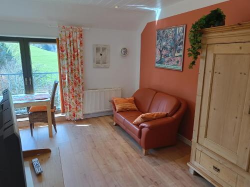 a living room with a couch and a table at Apartment Merle in Wimbach