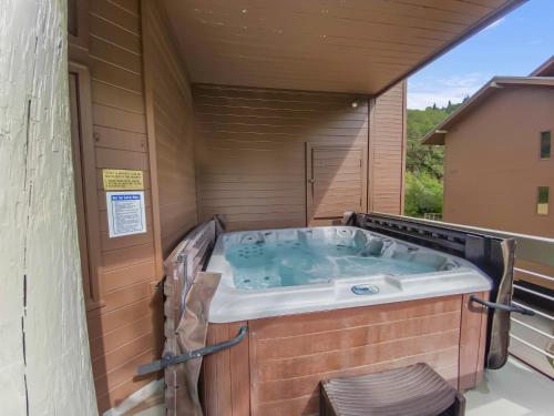 a jacuzzi tub in a house with a window at 24B Powder Run condo in Park City