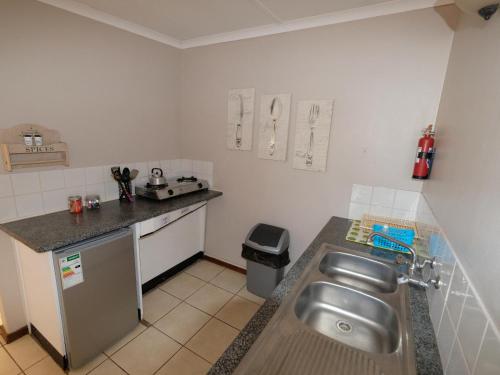 a small kitchen with a sink and a counter at Duwisib Guest Farm in Duwisib