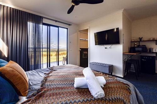 a hotel room with a bed with towels on it at Boutique Room - Wamoon Retreat in Yanakie