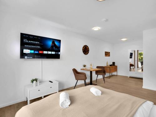 um quarto com duas camas e uma televisão na parede em INhome Studio Apartment - Küche - Parken - TV em Schwäbisch Hall