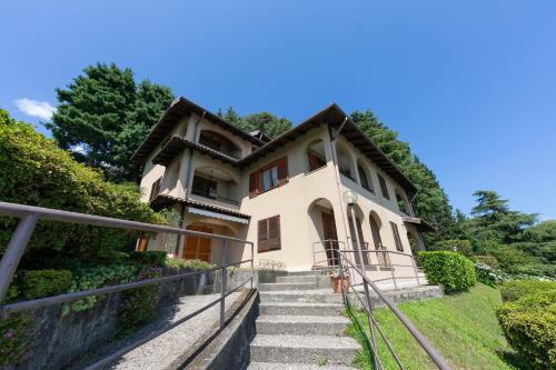 a house with stairs leading up to it at Pandora Lake View Stresa - Happy Rentals in Stresa