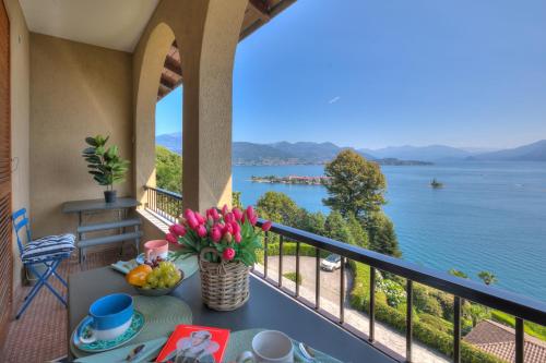 a balcony with a view of the water at Pandora Lake View Stresa - Happy Rentals in Stresa