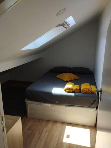 a bedroom with a bed with yellow towels on it at Katyto house in Costa da Caparica
