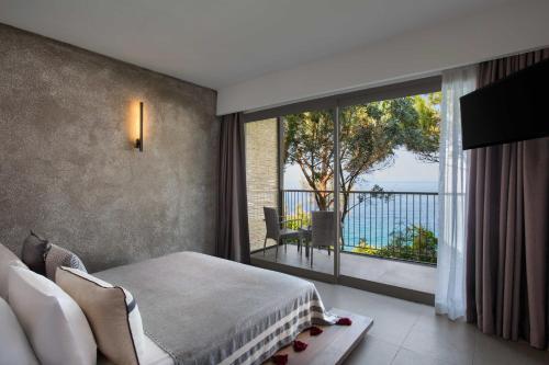 a bedroom with a bed and a large window at Club Marvy in Ozdere