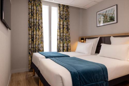Кровать или кровати в номере Hotel Charlemagne